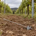 Galvanised trellis anchor on the soil at the end of a vineyard row